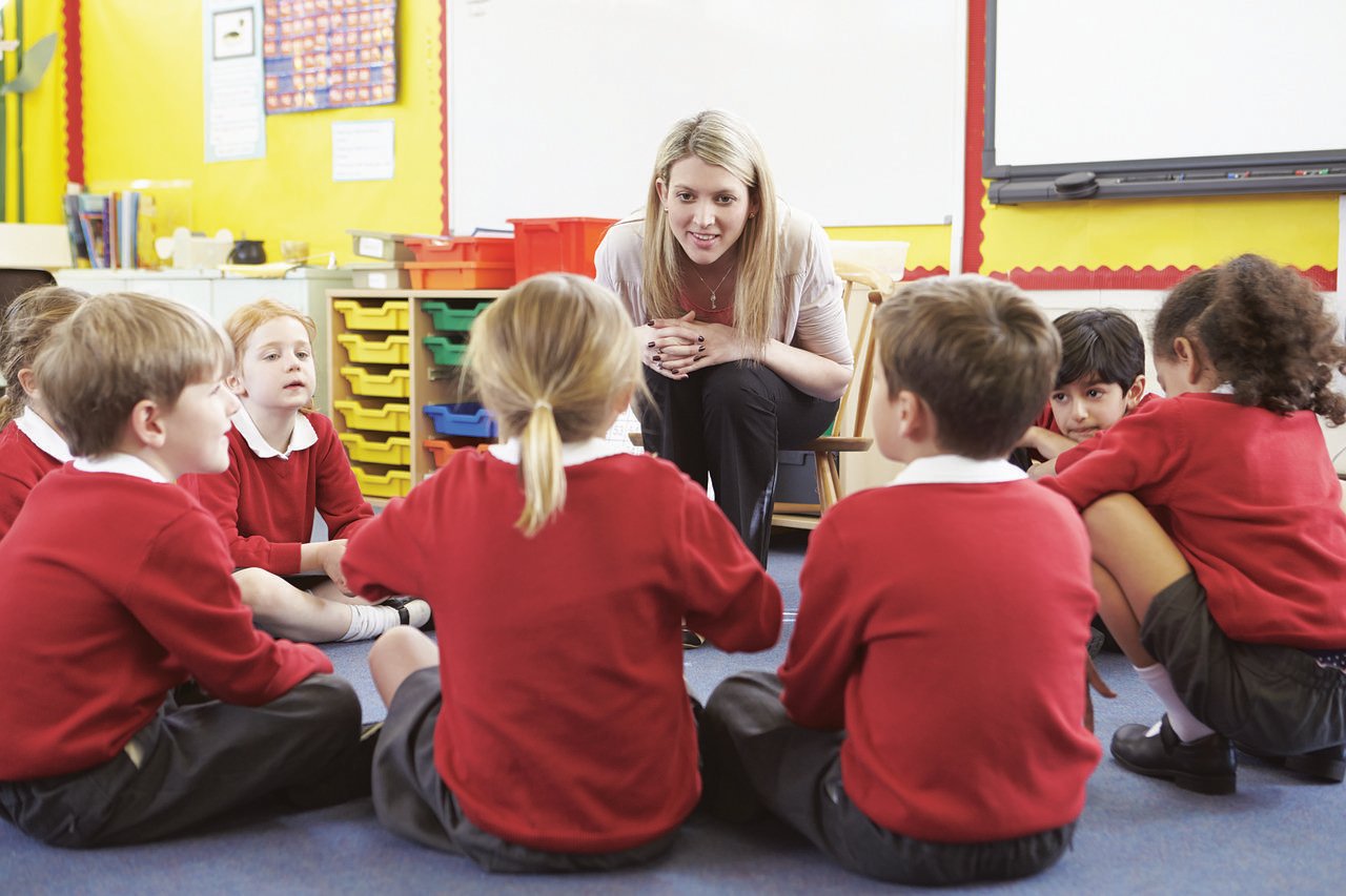 Teacher listening to children